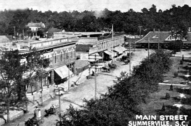 July 1906: Postcard: the west side and the depot